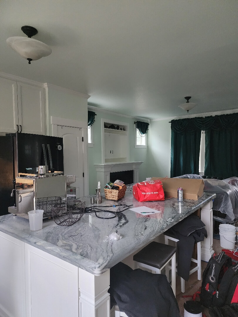 Modern kitchen island with pendant lighting and upgraded electrical outlets installed above countertop