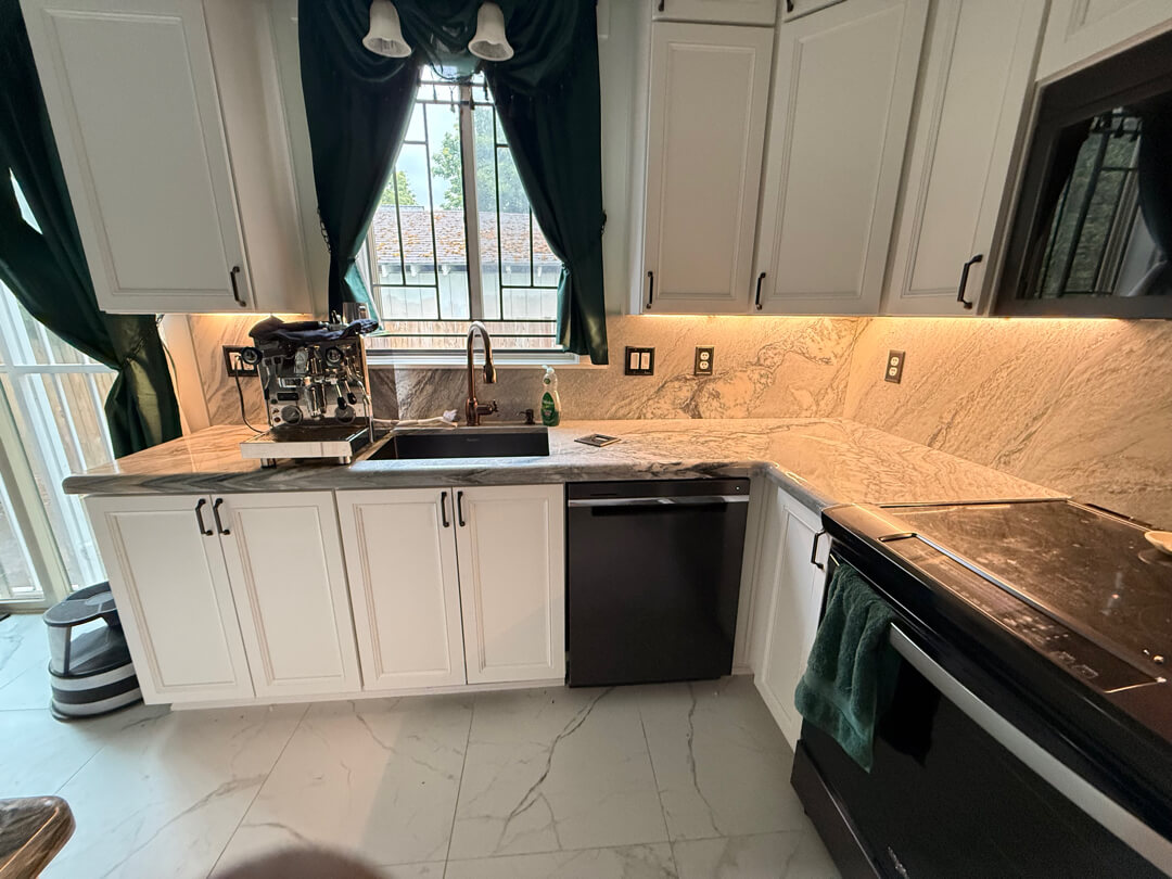 Modern kitchen with under cabinet lighting, outlets, and updated electrical work along backsplash