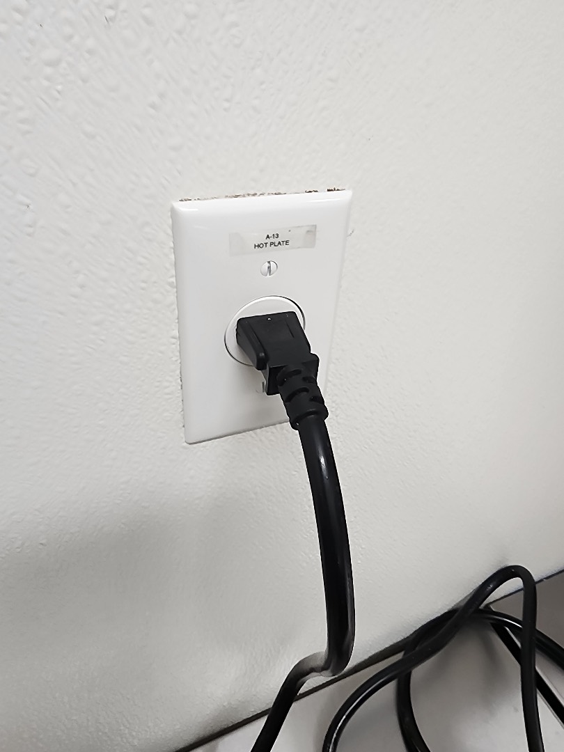 20-amp wall outlet with plugged-in equipment installed as part of commercial electrical upgrade in Portland OR