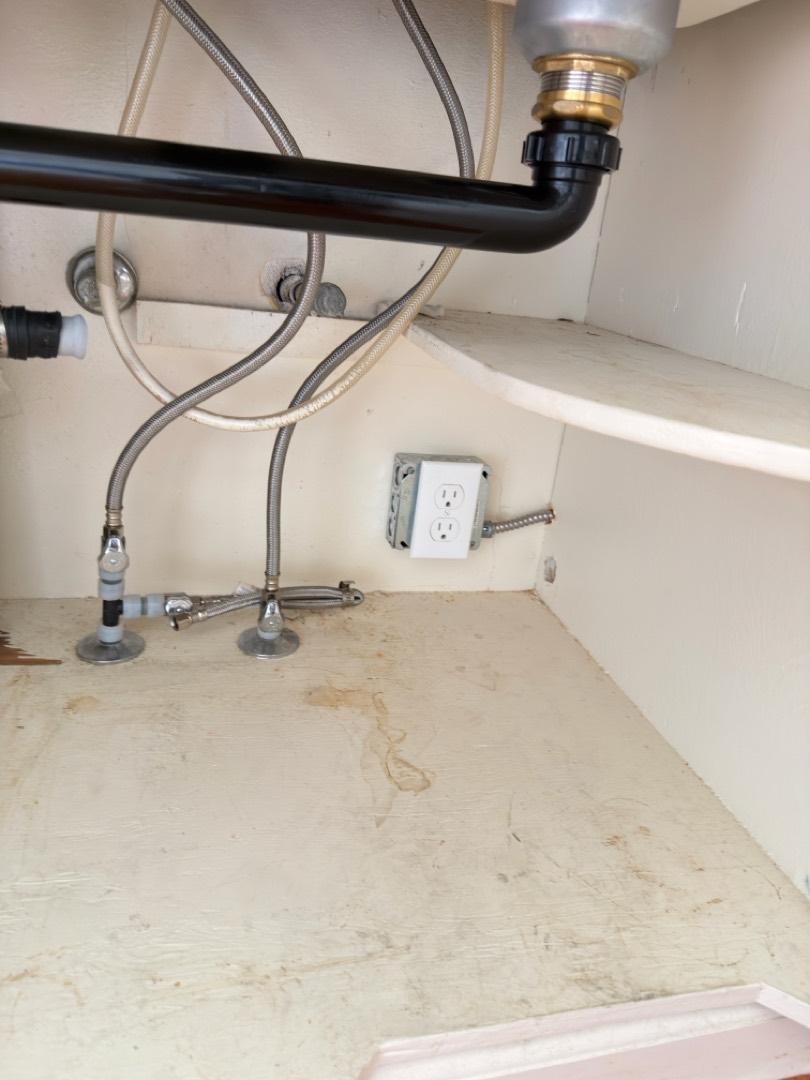 Dishwasher electrical outlet and plumbing connections installed under sink cabinet in Portland OR
