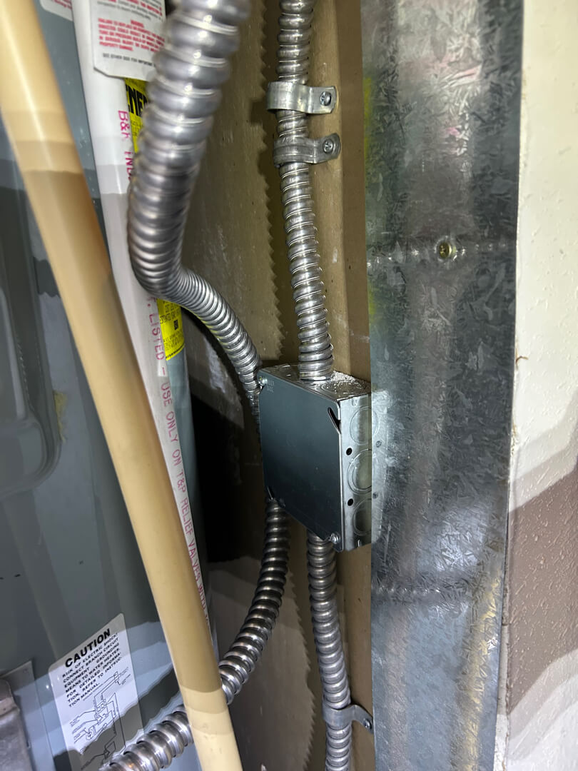 Electrical junction box with flexible conduit and wiring connections for water heater circuit extension in Mulino OR