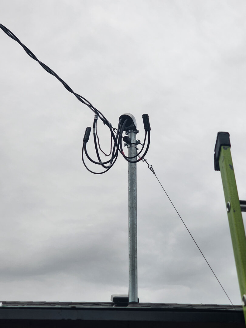 Overhead utility service lines connected to new electrical mast for 200 amp service upgrade in Portland OR