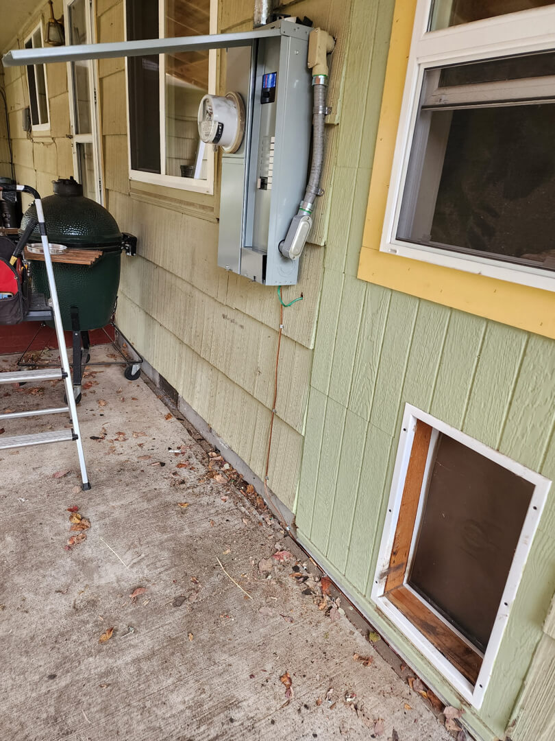 Exterior wall with installed meter main combo and conduit for 200 amp service upgrade in Portland OR
