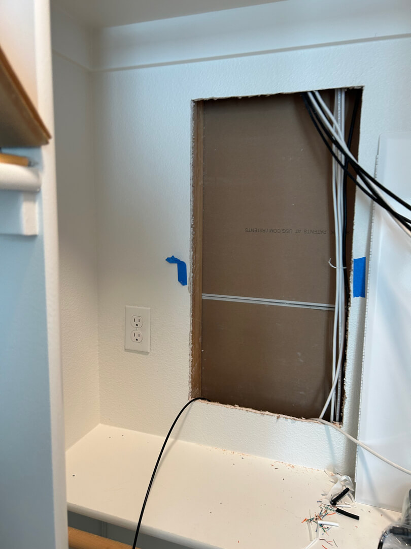 Closet area with wall opened and wiring exposed for new outlet installation in Portland OR