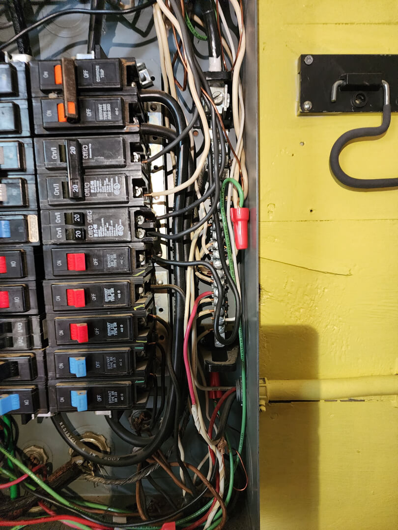Electrical panel interior with breakers and wiring for 200 amp meter main combo installation in Portland OR