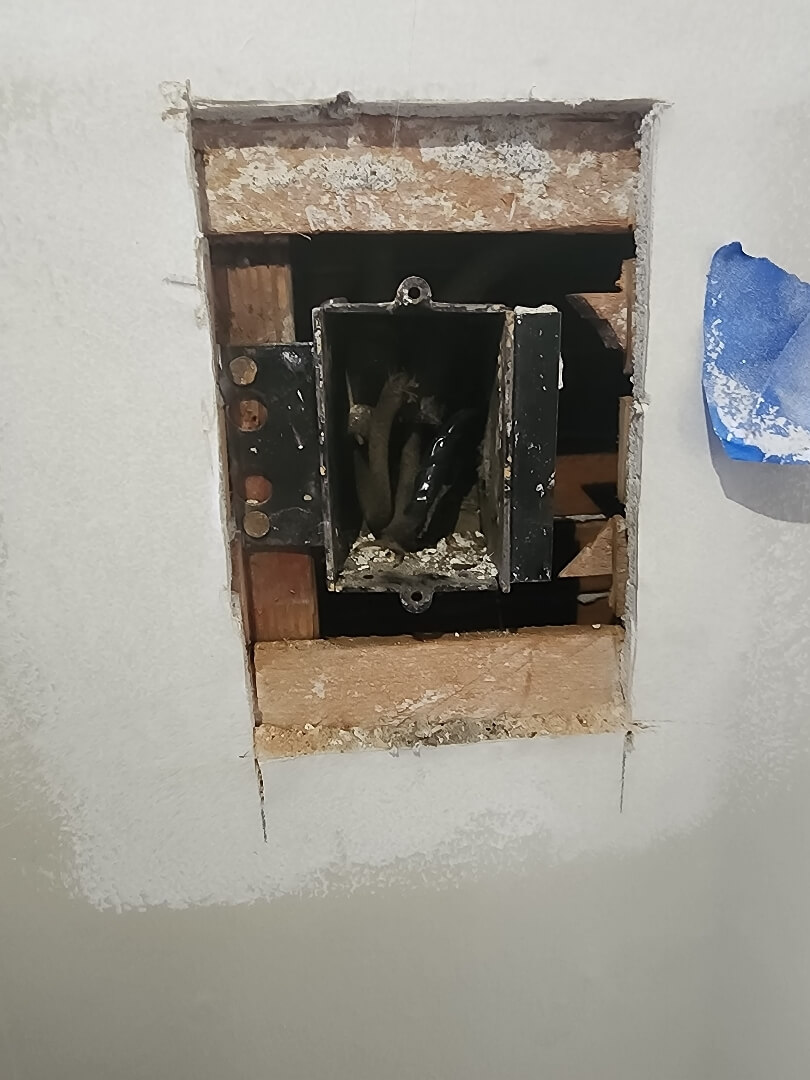 Old electrical box with outdated wiring exposed during electrical renovation in Portland OR