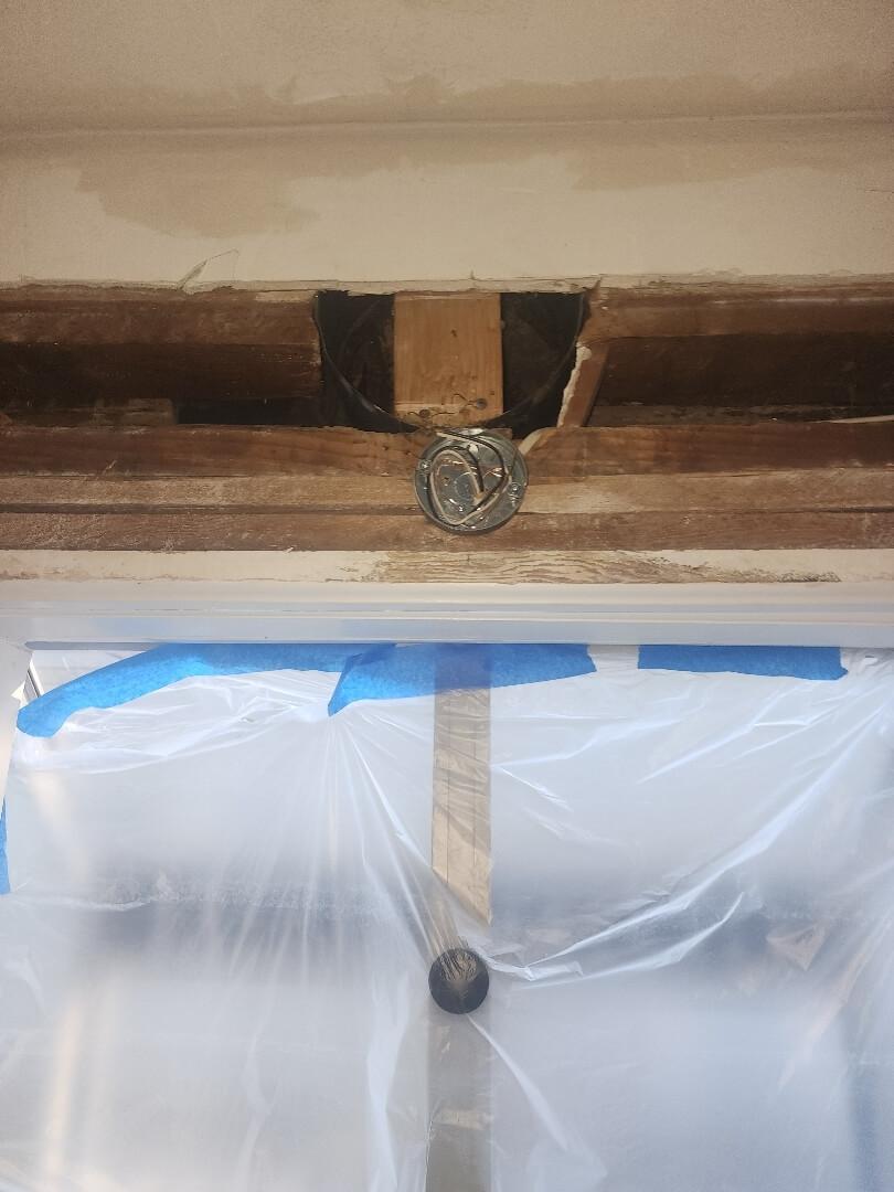 Exposed ceiling joists with updated electrical wiring access during knob and tube replacement project in Portland OR