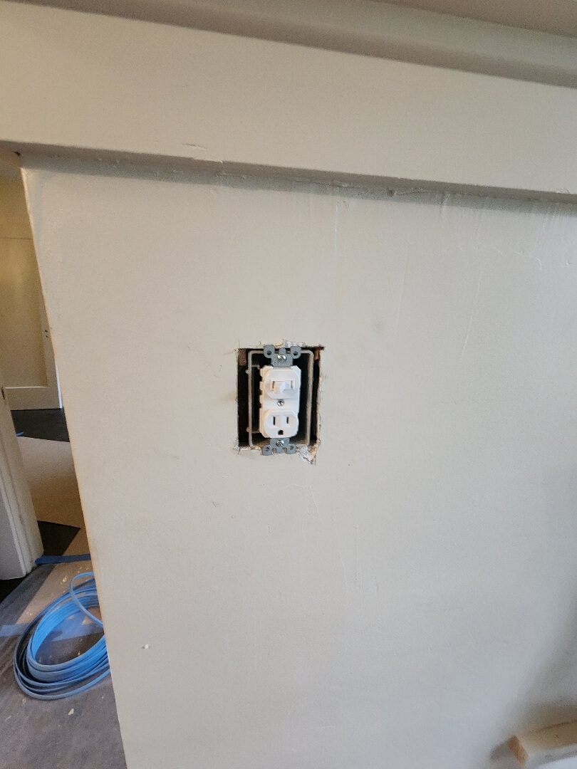 New electrical outlet box installed in wall during knob and tube wiring replacement project in Portland OR