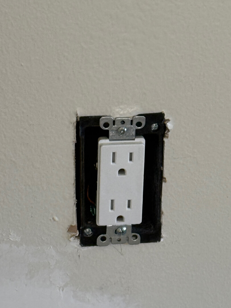 New electrical outlet installed on interior wall after wiring upgrade in Portland OR