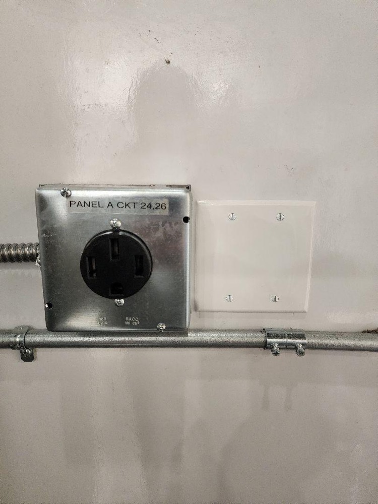 The finished 50-amp outlet, labeled Panel A circuits 24 and 26