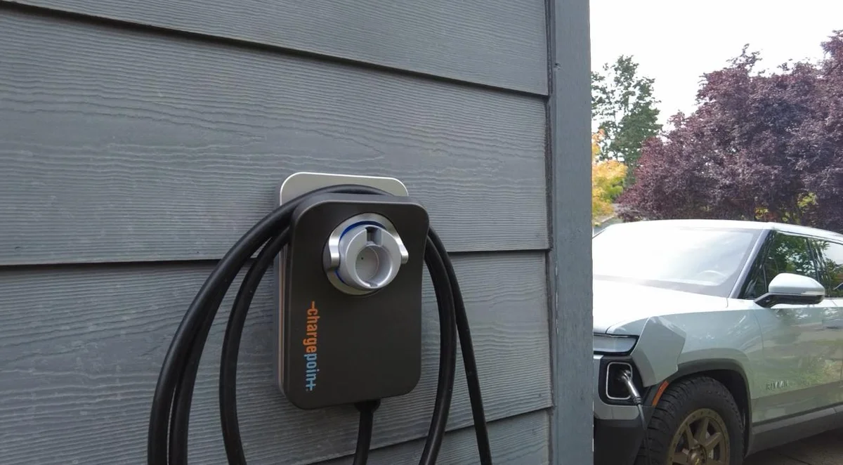 Outdoor ChargePoint home charger beside an electric vehicle