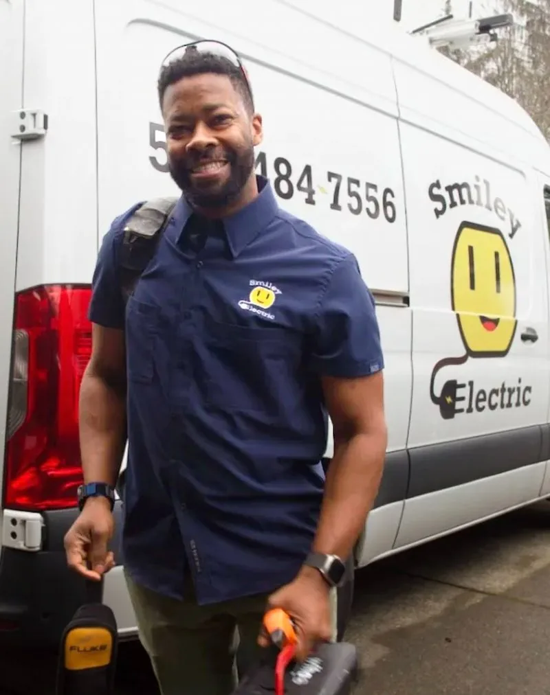 Josh at the Smiley Electric van with diagnostic tools in hand.