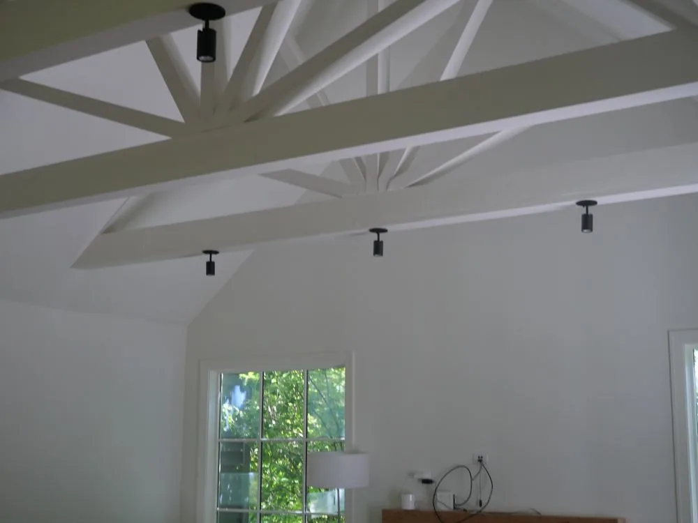 Recessed lighting installed across a vaulted ceiling.